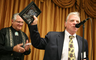 Bobby Clark thanked everyone for his award. Emcee John Buttram is behind him.