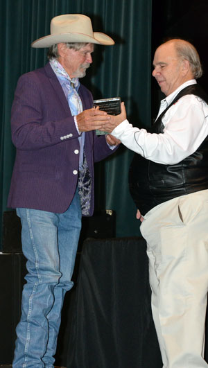 Buck Taylor is presented his award by Ray Nielsen.