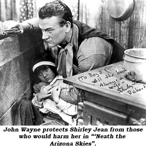 John Wayne protects Shirley Jean from those who would harm her in "'Neath the Arizona Skies".