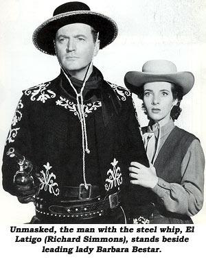 Unmasked, the man with the steel whip, El Latigo (Richard Simmons), stands beside leading lady Barbara Bestar.