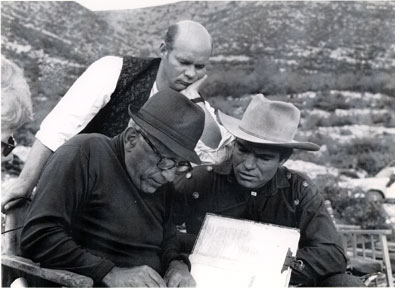 Director Robert Siodomak and star Kelo Henderson look over the script for the European made "Pyramid of the Sun God" ('65) with Kelo and Lex Barker. German actor Ralf Walter peers over their shoulders.