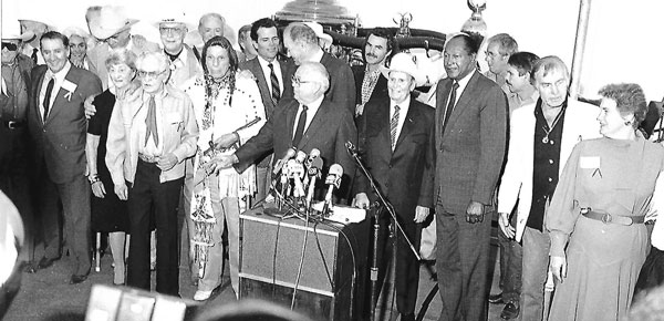 Ground-breaking ceremony (11/12/86) for the Gene Autry Museum, now known as the Autry Museum of the American West. (L-R) Clayton Moore, Pat Buttram, Mrs. Beverly Rogers, Sunset Carson, Mr. and Mrs. Bob Steele, Monte Hale, Buddy Rogers, Iron Eyes Cody, Patrick Wayne, L.A. City Councilman John Ferraro, emcee Johnny Grant, Burt Reynolds, Gene Autry, Mayor Tom Bradley, unknown, unknown, George Montgomery, Mrs. Gene (Jackie) Autry. 