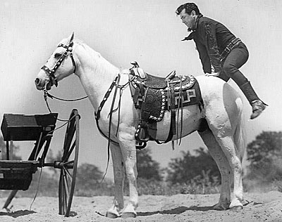 Johnny Mack Brown caught in mid-air performing a crupper mount. 