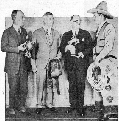 World’s Champion Cowboy Yakima Canutt (right) headlined the World’s Show Sensations sponsored by the Toledo, OH Shrine club in January 1930. (L-R) Harry Haskell, Ben Groenewold and Mayor William T. Jackson holding some of Yak’s trophies.