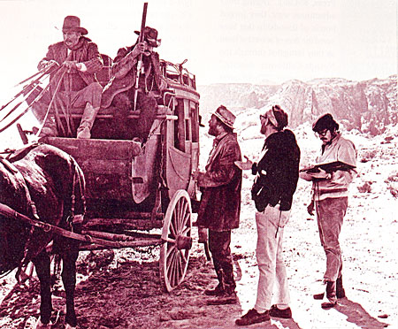 Filming a scene for ‘The Ballad of Cable Hogue’ (‘70) are director Sam Peckinpah (wearing the bandana), Jason Robards, Slim Pickens (stage driver) and author Max Evans (shotgun guard) in his only acting role. Script supervisor stands by.