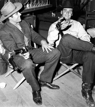 Rex Reason and James Garner take a break from filming a “Maverick”.