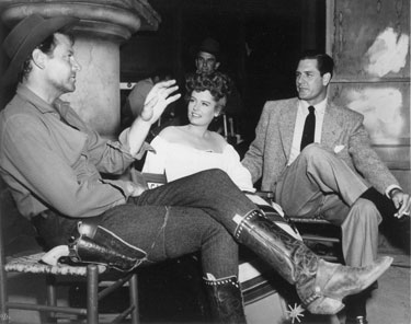 Informal discussion on the set of “South of St. Louis” with Joel McCrea, Alexis Smith and Smith’s actor/husband Craig Stevens. (‘49) 