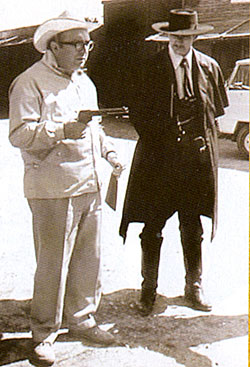 Director Sergio Leone shows Lee Van Cleef exactly how he wants Van Cleef’s shooting stance to be for a scene in “For a Few Dollars More”. (Courtesy RetroFan magazine.) 