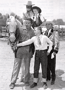 The Lone Ranger and Tonto at the Sheriff's Rodeo in the L.A. Colisseum with children Joan and William Mohr and Sheriff E. W. Biscailuz. 