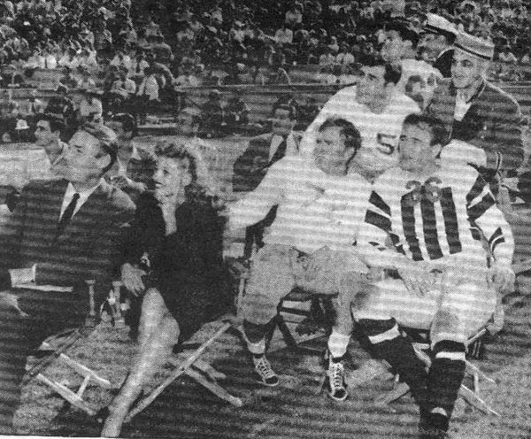 Between halves of the Leading Men-Comedians Football Game, Randolph Scott, Rita Hayworth, Don Barry, unidentified and John Wayne watch film stuntmen put on a musical acrobatic rodeo. Year unknown. (Thanx to Billy Holcomb.)