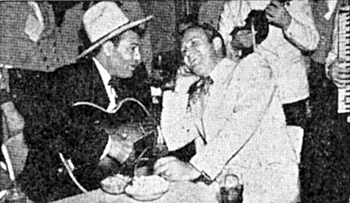 The Manassa Mauler, Jack Dempsey, World Heavyweight Champion from 1919-1926, clowns around with Gene Autry. 