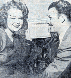 Clara Bow holds up a confirming document that she and Rex Bell were sceretly married in Las Vegas, NV, on December 3, 1931. 