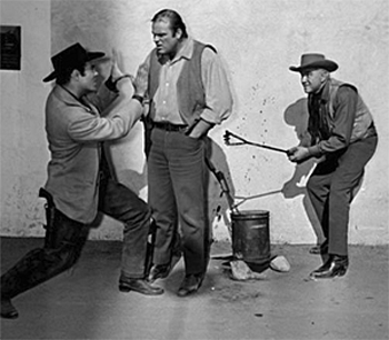 Clowning around on the "Bonanza" set with Pernell Roberts, Dan Blocker and Lorne Greene. Watch that branding iron Hoss!