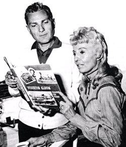 Producer Arthur Gardner and Barbara Stanwyck look over the STOCKTON ALBUM in preparation for "The Big Valley" series. 