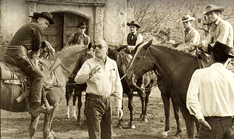 Director John Sturges readies a scene for "The Magnificent Seven" with (L-R) Yul Brynner, Horst Buchholz, Robert Vaughn, Steve McQueen, James Coburn. 