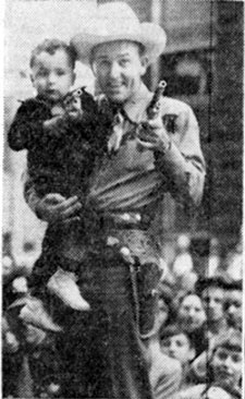 Monogram B-western star Jimmy Wakely shows 3-year-old Jerry Merlo of Calumet City, IL, how to be a cowboy during Jimmy’s personal appearance at Goldblatts’ department store in Hammond, IL, circa late ‘40s. Jimmy and the Saddlepals were being featured at the time at the American Legion Rodeo at Soldier’s Field in Chicago.