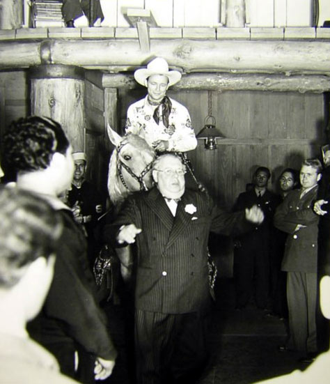 Roy Rogers and Trigger give a little nudge to comic actor S. Z. “Cuddles” Sakall at the Hollywood Canteen, sometime in the ‘40s.