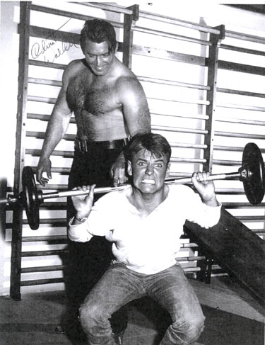 Will "Sugarfoot" Hutchins and Clint "Cheyenne" Walker working out in the Warner Bros. gym circa 1960. Will captioned this photo for us, "I'm tryin' to raise your spirits."