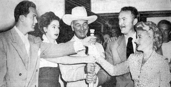 Kirk Alyn (left), Virginia O’Brien, William Boyd, Albert Dekker and Grace Bradley Boyd choose sides before a ‘50s Movie Stars World Series charity game at Wrigley Field in Chicago.