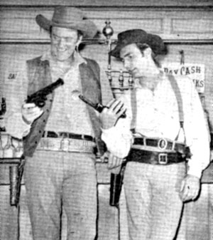 James Arness as Matt Dillon and Dennis Weaver as Chester Goode laughingly compare guns on “Gunsmoke”. 