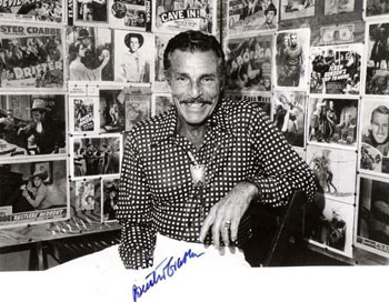 Buster Crabbe surrounded by lobby cards and photos from his western/serial career. (Thanx to Jerry Whittington.)