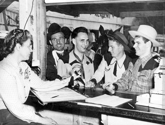 At his Heaven on Earth ranch in the San Fernando Valley, Johnny Carpenter used to help the blind to ride horses. Here Johnny makes reservations at his stable for Dale Reed, Russell Kennedy and Jimmy Pruett.