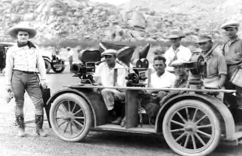 Circa mid-‘20s, Tom Mix stands beside a camera truck. (Thanx to Page Williams.)