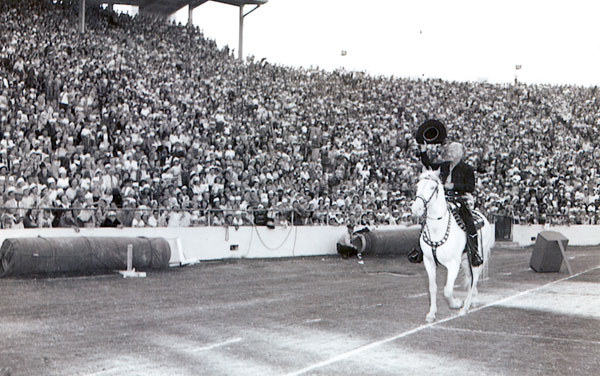 Hopalong Cassidy waves to an adoring audience at the Cotton Bowl in Dallas, TX, in October 1952.