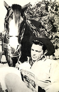 Dale Robertson studies a “Wells Fargo” script between scenes.