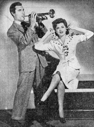 Out of Western garb in 1942 to make “Orchestra Wives” are George Montgomery and Gene Autry leading lady Ann Rutherford.