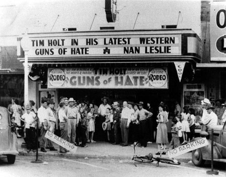 What a day this must have been in Mangum, OK, in August 1948! RKO's Tim Holt was in Mangum for a rodeo and parade and stopped off at not just one, but two, theatres both showing "Guns of Hate" ('48). Top photo shows Tim at the Temple Theatre with the bottom photo taken at the Greer Theatre the same day. (Photos courtesy Billy Holcomb.)